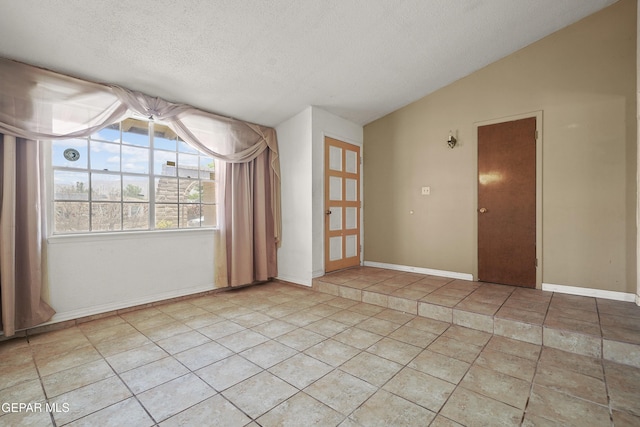 4112 Blackstone Ct, El Paso, TX 79922 - empty room featuring a textured ceiling, vaulted ceiling, and baseboards