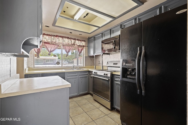 4112 Blackstone Ct, El Paso, TX 79922 - kitchen with black appliances, gray cabinetry, light tile patterned flooring, decorative backsplash, and a sink