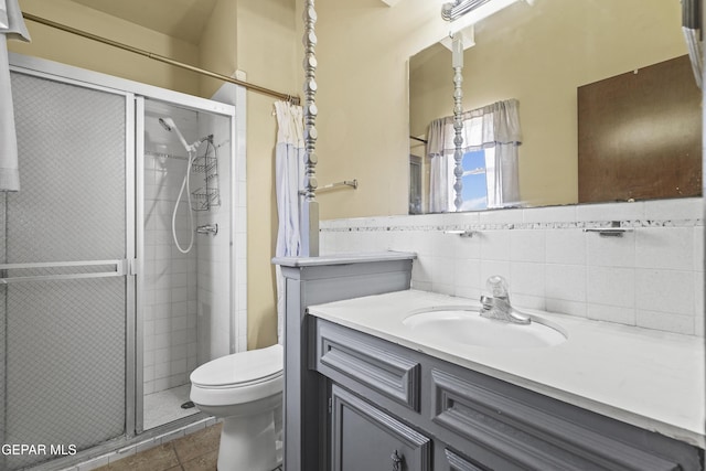 4112 Blackstone Ct, El Paso, TX 79922 - bathroom with vanity, a stall shower, toilet, and tile walls