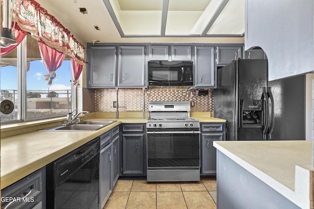 4112 Blackstone Ct, El Paso, TX 79922 - kitchen featuring black appliances, gray cabinets, a sink, light countertops, and tasteful backsplash