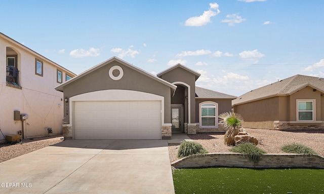 1129 Indigo Sky St, El Paso, TX 79928 - view of front of home with stone siding, driveway, an attached garage, and stucco siding