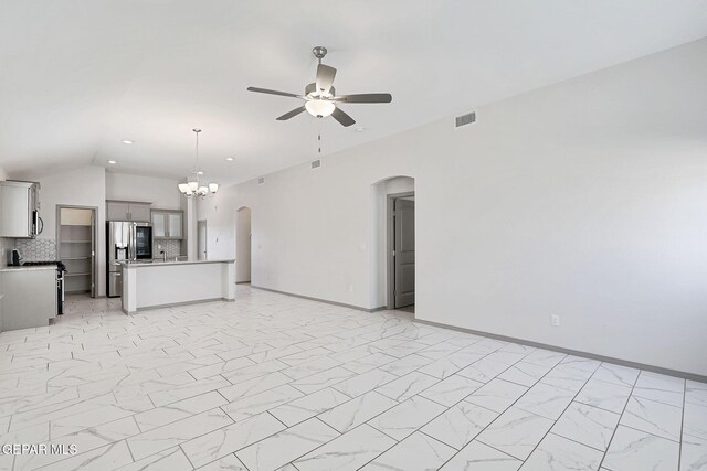 1129 Indigo Sky St, El Paso, TX 79928 - unfurnished living room featuring arched walkways, ceiling fan, a chandelier, vaulted ceiling, and light marble finish floors