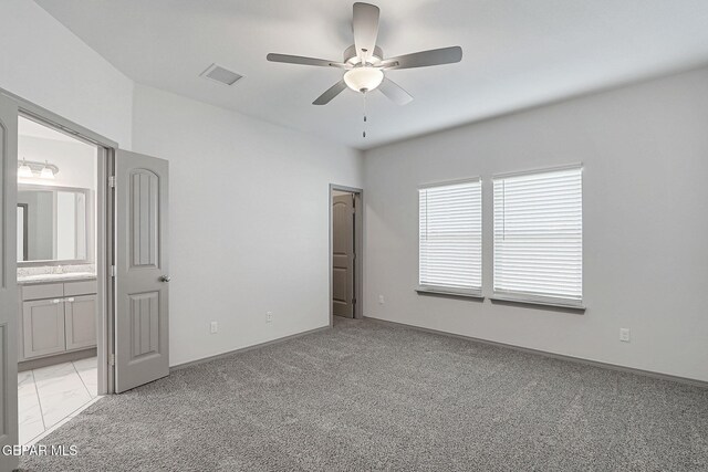 1129 Indigo Sky St, El Paso, TX 79928 - unfurnished bedroom with ensuite bathroom, light carpet, baseboards, a ceiling fan, and a sink