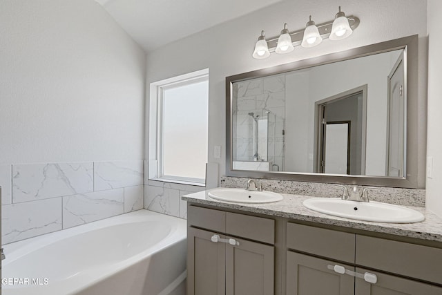 1129 Indigo Sky St, El Paso, TX 79928 - full bathroom featuring double vanity, a garden tub, and a shower stall
