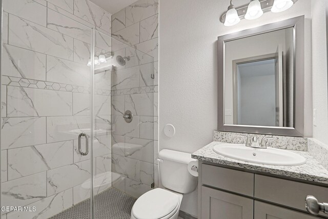1129 Indigo Sky St, El Paso, TX 79928 - bathroom with vanity, toilet, a stall shower, and a textured wall