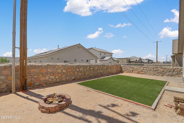 1129 Indigo Sky St, El Paso, TX 79928 - fenced backyard featuring a fire pit