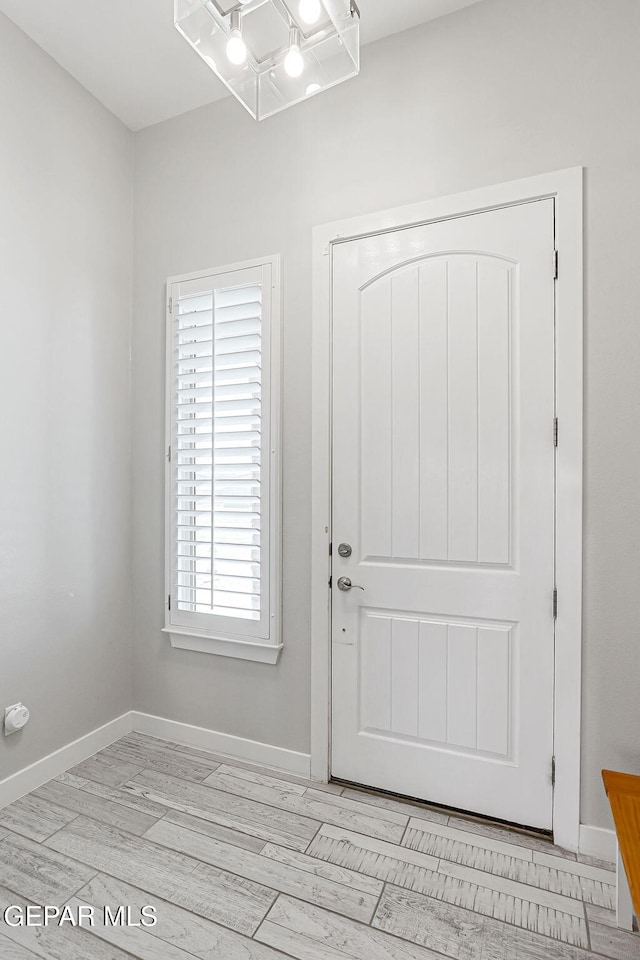 14733 Charles Foster Ave, El Paso, TX 79938 - foyer with baseboards and light wood-style flooring