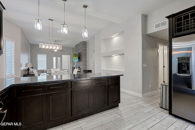14733 Charles Foster Ave, El Paso, TX 79938 - kitchen featuring stainless steel fridge with ice dispenser, open floor plan, dark stone counters, baseboards, and pendant lighting