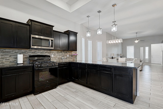 14733 Charles Foster Ave, El Paso, TX 79938 - kitchen featuring stainless steel microwave, gas stove, backsplash, a ceiling fan, and open floor plan