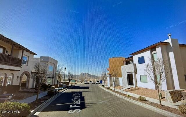 521 S Festival Dr, El Paso, TX 79912 - view of asphalt road with curbs, sidewalks, and street lighting