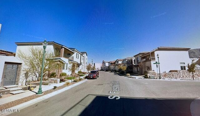 521 S Festival Dr, El Paso, TX 79912 - view of asphalt street with a residential view, sidewalks, and curbs