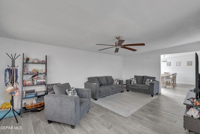 10109 Saigon Dr, El Paso, TX 79925 - living area with a ceiling fan, wood finish floors, and a textured ceiling