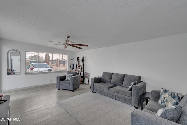 10109 Saigon Dr, El Paso, TX 79925 - living room featuring a ceiling fan, a textured ceiling, and light wood-style floors