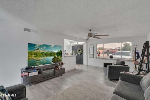10109 Saigon Dr, El Paso, TX 79925 - living room with a textured ceiling, a ceiling fan, and wood finished floors