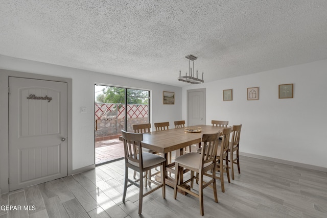 10109 Saigon Dr, El Paso, TX 79925 - dining room featuring a textured ceiling, light wood finished floors, and baseboards