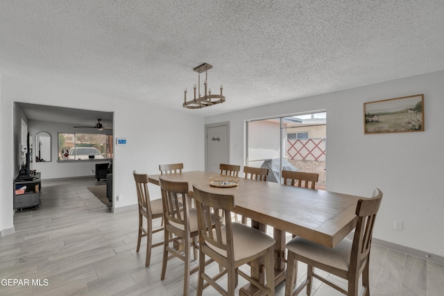 10109 Saigon Dr, El Paso, TX 79925 - dining room with a wood stove, healthy amount of natural light, a textured ceiling, baseboards, and ceiling fan