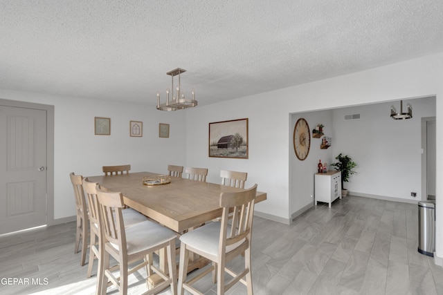 10109 Saigon Dr, El Paso, TX 79925 - dining room featuring a textured ceiling and baseboards
