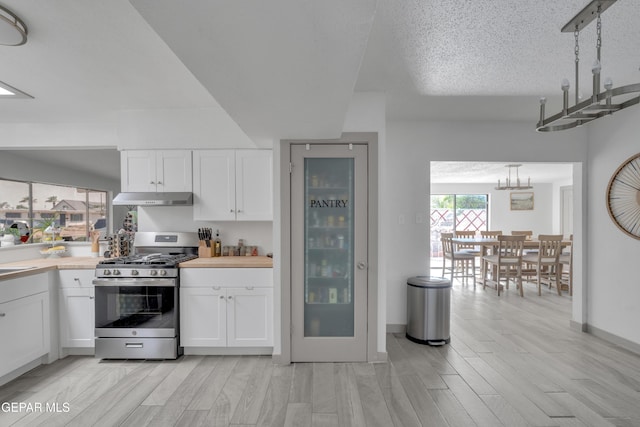 10109 Saigon Dr, El Paso, TX 79925 - kitchen featuring stainless steel range with gas stovetop, under cabinet range hood, a chandelier, white cabinets, and light countertops