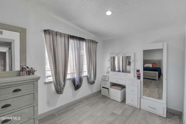 10109 Saigon Dr, El Paso, TX 79925 - bedroom featuring a textured ceiling, baseboards, and light wood-type flooring