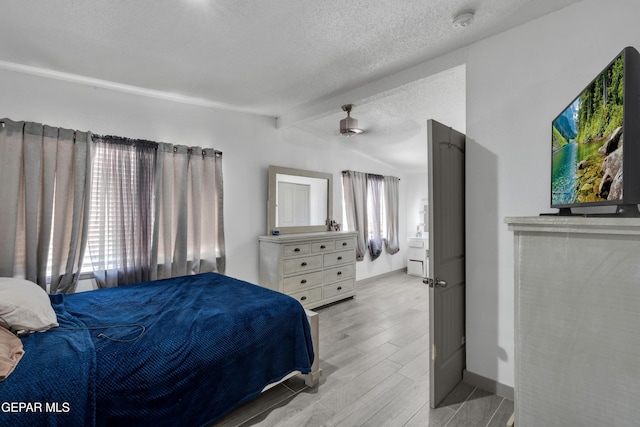 10109 Saigon Dr, El Paso, TX 79925 - bedroom featuring a textured ceiling, wood tiled floors, and baseboards