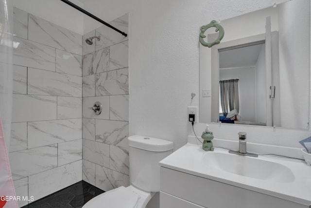 10109 Saigon Dr, El Paso, TX 79925 - bathroom with vanity, a tile shower, and toilet