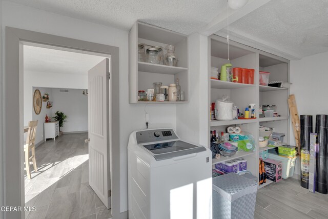 10109 Saigon Dr, El Paso, TX 79925 - washroom featuring washer / clothes dryer, a textured ceiling, and light wood-style floors