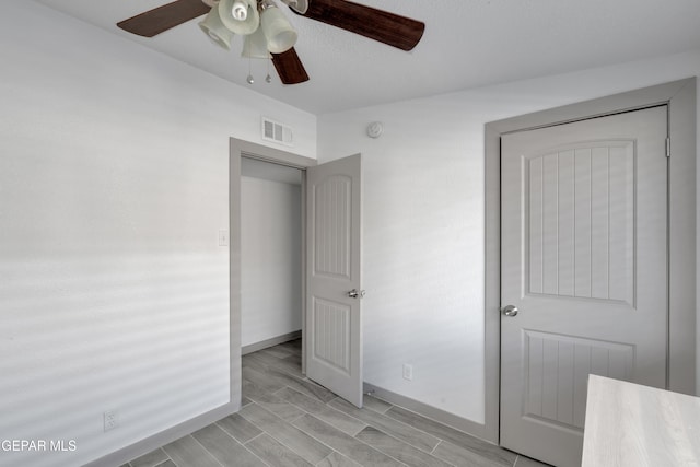10109 Saigon Dr, El Paso, TX 79925 - unfurnished bedroom featuring baseboards, a ceiling fan, and wood tiled floors