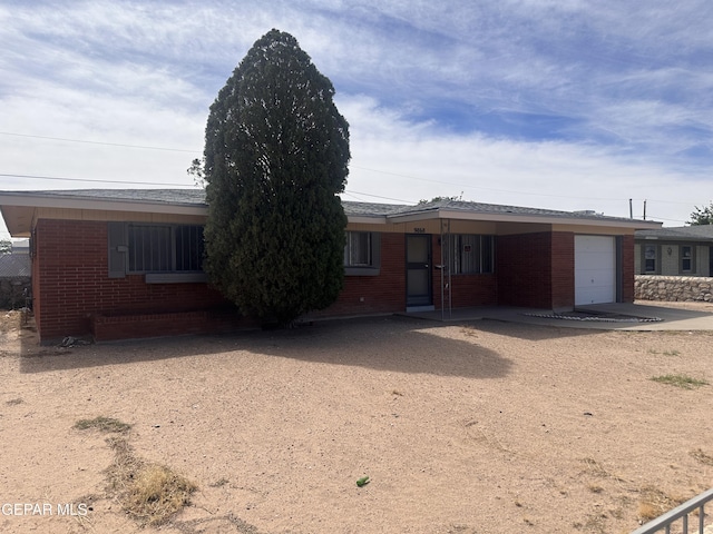 9868 Bomarc St, El Paso, TX 79924 - single story home featuring brick siding, a garage, and driveway