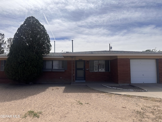 9868 Bomarc St, El Paso, TX 79924 - ranch-style home featuring brick siding, an attached garage, and concrete driveway