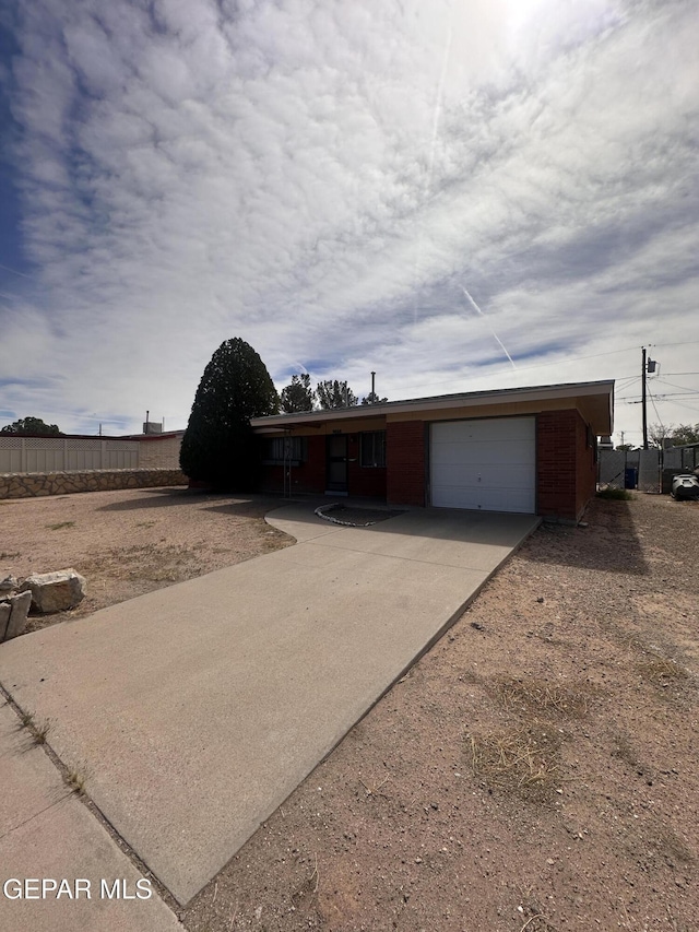 9868 Bomarc St, El Paso, TX 79924 - ranch-style home with a garage and driveway