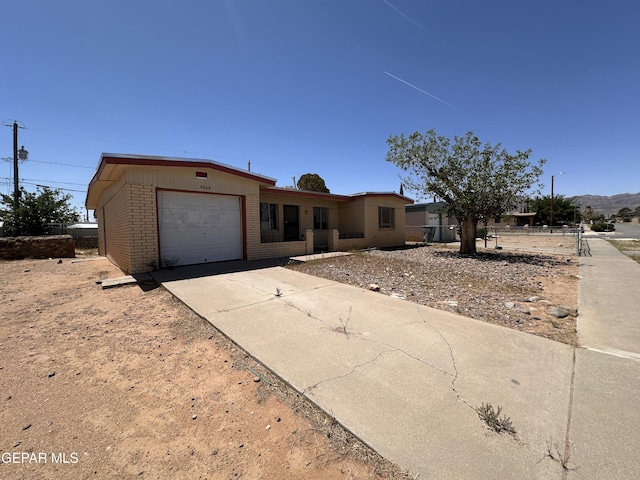 5604 Sarah Anne Ave, El Paso, TX 79924 - view of front facade with brick siding, an attached garage, and driveway