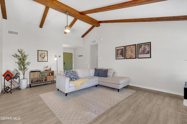 11185 Tenaha Ave, El Paso, TX 79936 - living area with beam ceiling, light wood-type flooring, high vaulted ceiling, and baseboards