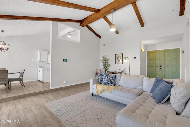 11185 Tenaha Ave, El Paso, TX 79936 - living room with light wood finished floors, a chandelier, and baseboards