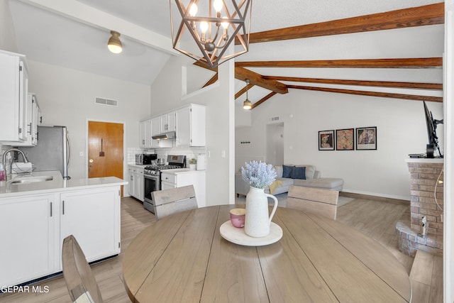 11185 Tenaha Ave, El Paso, TX 79936 - dining space with beam ceiling, light wood-style flooring, a chandelier, high vaulted ceiling, and baseboards