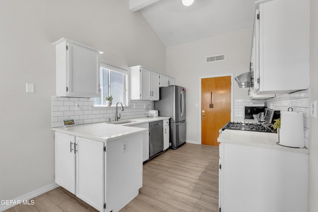 11185 Tenaha Ave, El Paso, TX 79936 - kitchen featuring a sink, high vaulted ceiling, stainless steel appliances, backsplash, and white cabinets