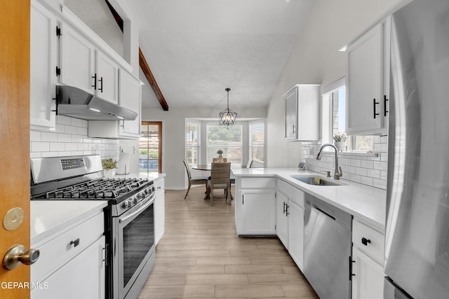 11185 Tenaha Ave, El Paso, TX 79936 - kitchen featuring stainless steel appliances, a sink, under cabinet range hood, a textured ceiling, and light countertops