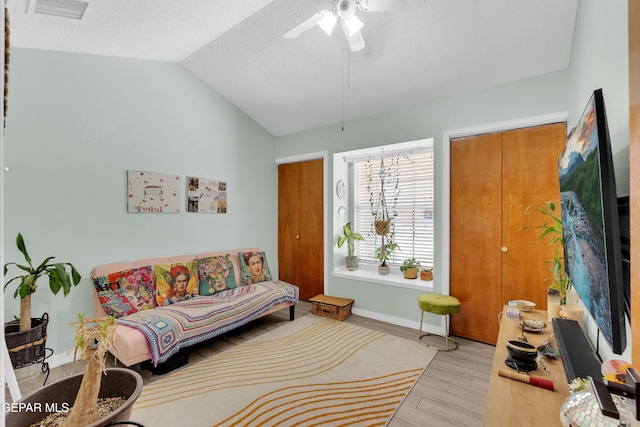11185 Tenaha Ave, El Paso, TX 79936 - living area featuring vaulted ceiling, a textured ceiling, ceiling fan, wood finished floors, and baseboards