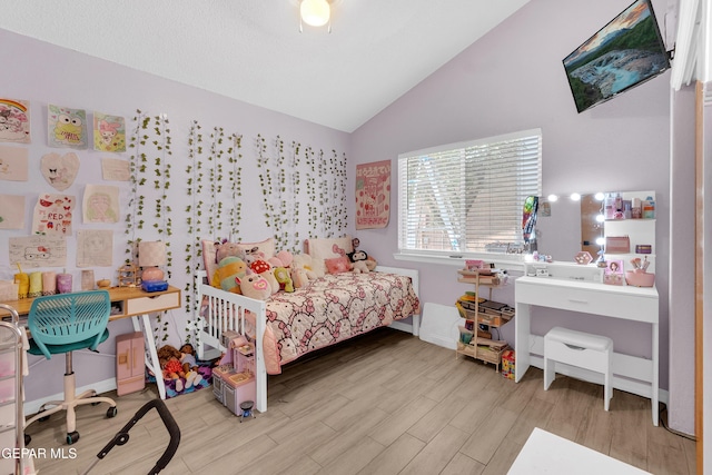 11185 Tenaha Ave, El Paso, TX 79936 - bedroom featuring wood finished floors and high vaulted ceiling