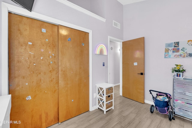 11185 Tenaha Ave, El Paso, TX 79936 - bedroom with light wood-style floors, baseboards, and a towering ceiling