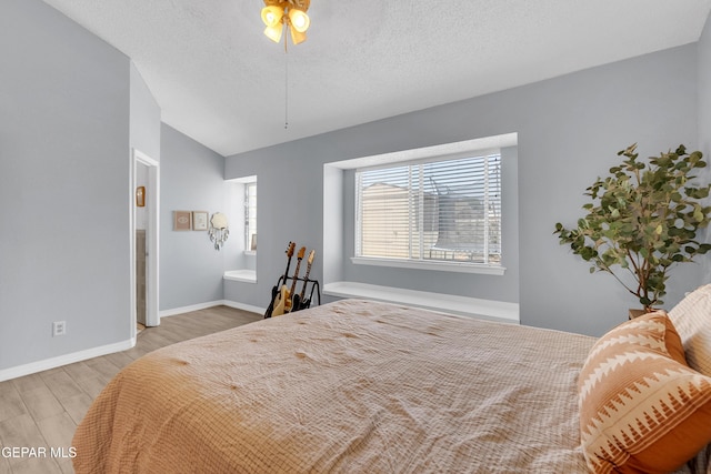 11185 Tenaha Ave, El Paso, TX 79936 - bedroom with wood finished floors, baseboards, and a textured ceiling