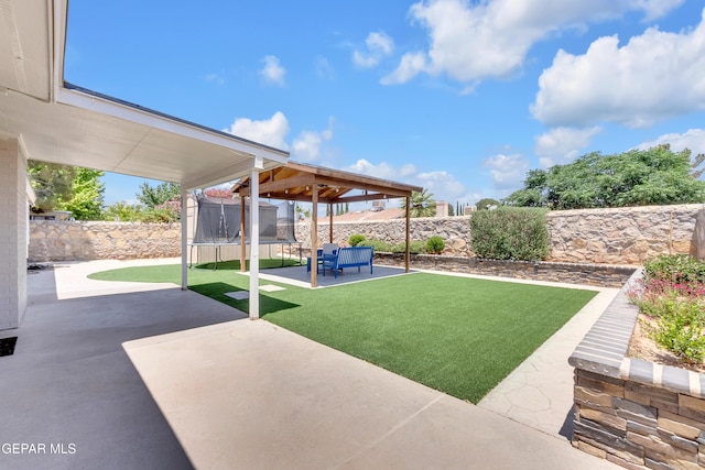 11185 Tenaha Ave, El Paso, TX 79936 - view of yard with a trampoline, a patio area, and a gazebo