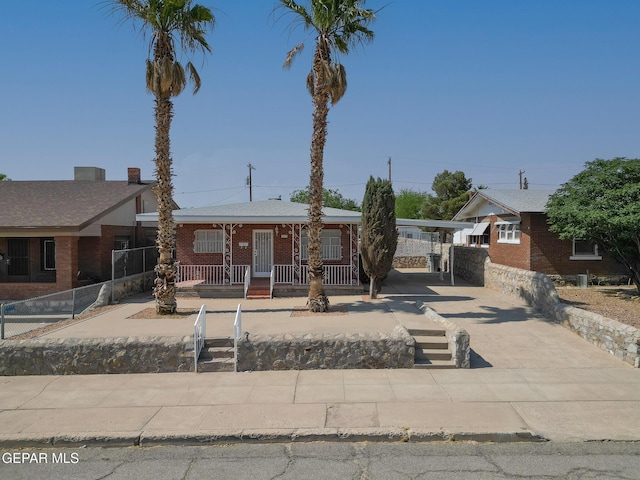 4013 Hueco Ave, El Paso, TX 79903 - view of front facade with covered porch, driveway, and brick siding