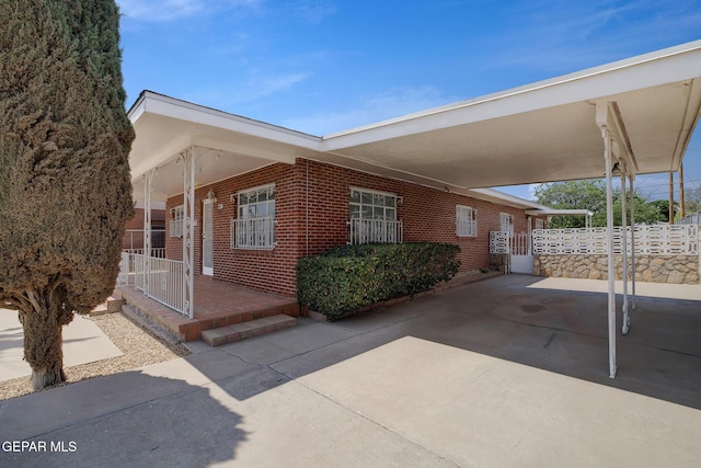 4013 Hueco Ave, El Paso, TX 79903 - view of side of property featuring brick siding and a carport