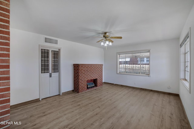 4013 Hueco Ave, El Paso, TX 79903 - unfurnished living room with wood finished floors, ceiling fan, a fireplace, and baseboards