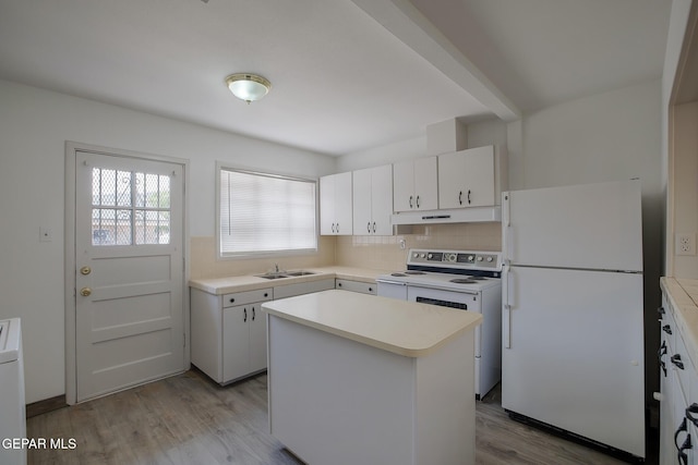 4013 Hueco Ave, El Paso, TX 79903 - kitchen with white appliances, under cabinet range hood, light countertops, and wood finished floors