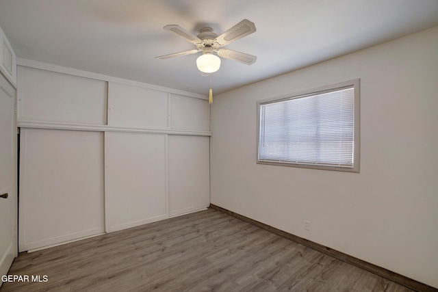 4013 Hueco Ave, El Paso, TX 79903 - unfurnished bedroom featuring light wood finished floors, a closet, baseboards, and ceiling fan