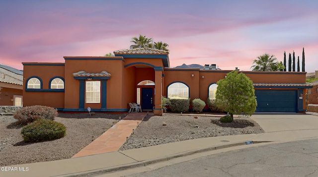 904 Las Palmas Way, El Paso, TX 79912 - mediterranean / spanish-style house featuring a garage, concrete driveway, stucco siding, and a tiled roof