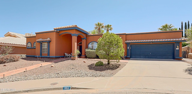 904 Las Palmas Way, El Paso, TX 79912 - view of front of home with driveway, an attached garage, and stucco siding