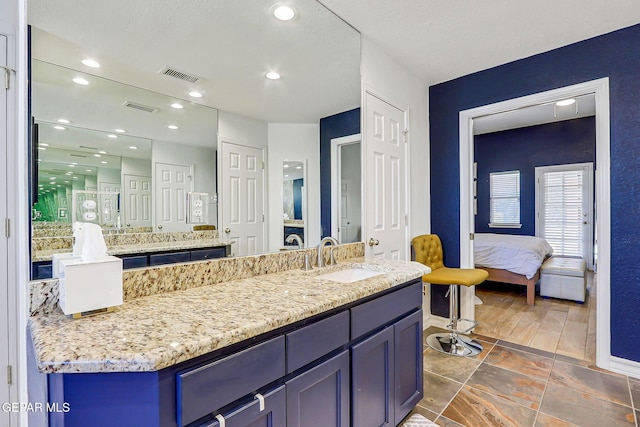 904 Las Palmas Way, El Paso, TX 79912 - ensuite bathroom with vanity, baseboards, and recessed lighting