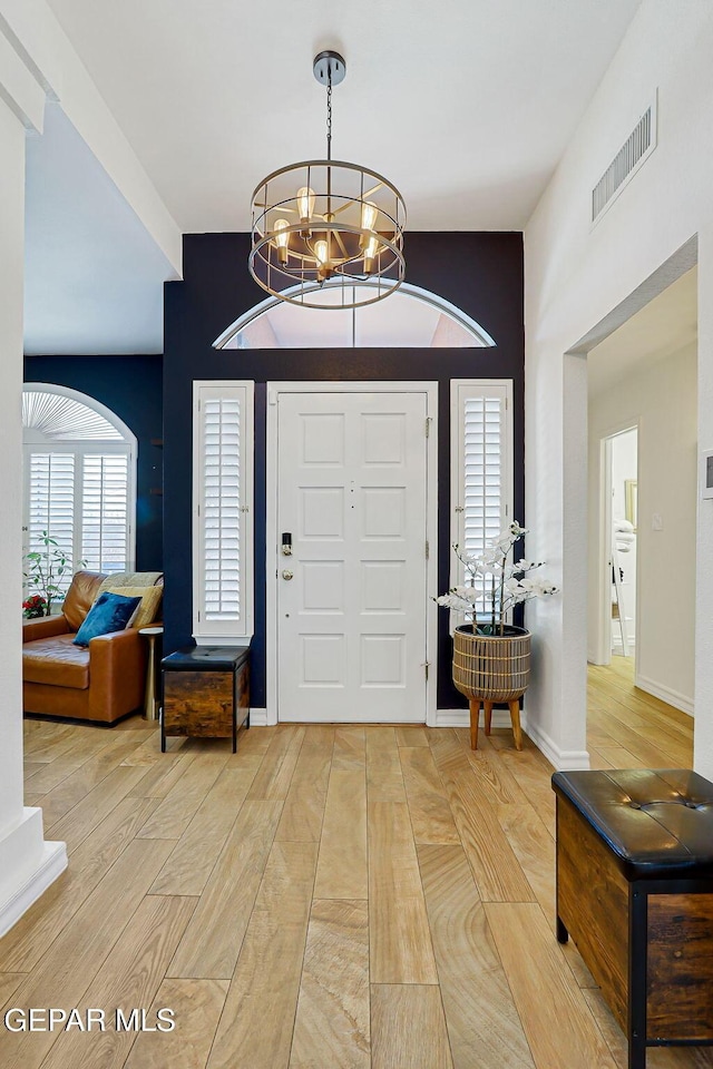 904 Las Palmas Way, El Paso, TX 79912 - foyer with light wood-style floors and a chandelier